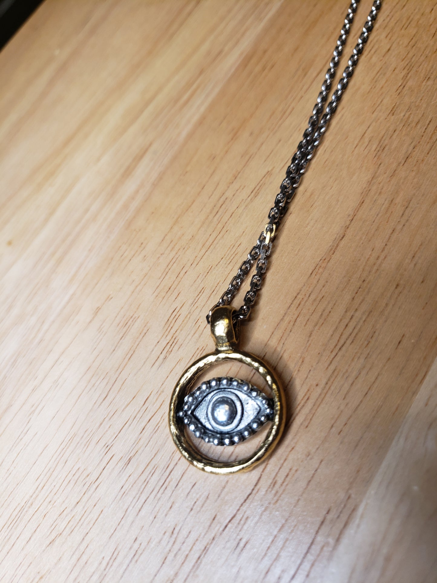 Silver and gold evil eye pendant